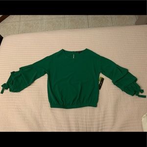 Green ruffled long sleeved blouse